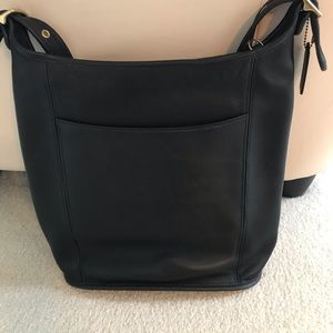 A navy blue coach bag.